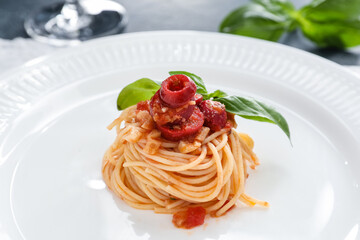 Plate with tasty Pasta Puttanesca on table, closeup