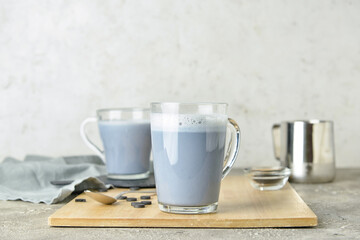 Obraz na płótnie Canvas Glass cups of tasty Charcoal Latte on table