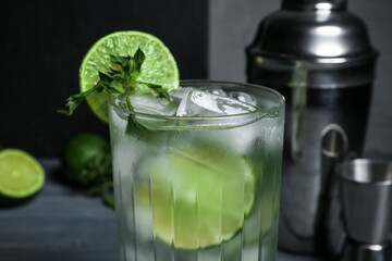 Glass of fresh mojito on table, closeup