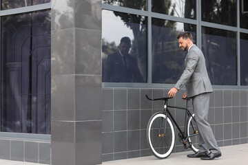 Businessman with bicycle on city street