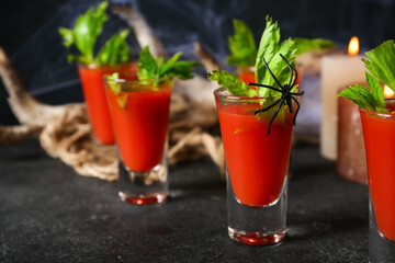 Shots of tasty bloody Mary cocktail decorated for Halloween on dark background
