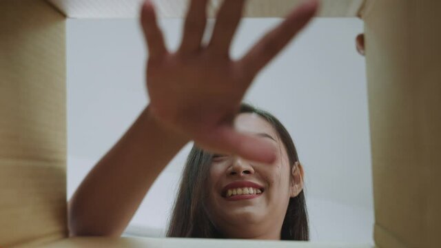  transgender transgender Beautiful Asian woman picking things out of the box.
