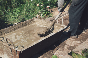 Mixing cement to fill the garden path, garden construction work