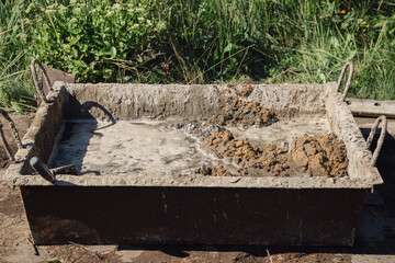 Kneading cement for pouring garden path, garden construction work