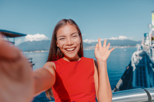 Asian Business Woman Selfie Waving Hello Looking At Camera On Video Call Calling For Online Work Meeting While Walking Outside On Travel. Coal Harbour, Vancouver, Canada.