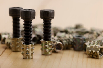 Steel anchor bolts on wooden background , Equipment for wood construction