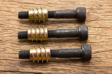 Steel anchor bolts on wooden background , Equipment for wood construction