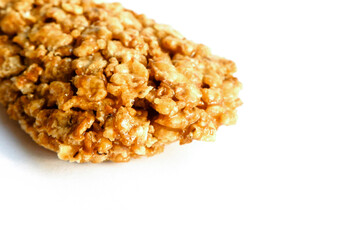 Cereal bar on white background. Healthy dessert snack. Cropped close-up view