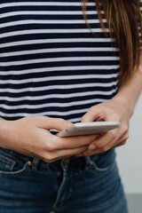 Young woman holding a smartphone only the hands are shown