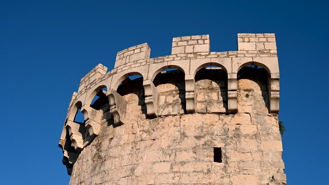 Old stone tower in historic town. Walls and towers in old castle. Korcula, Croatia.	