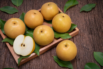 Fresh Snow pear fruit in wooden plate, Fresh Korea pear fruit on wooden background.
