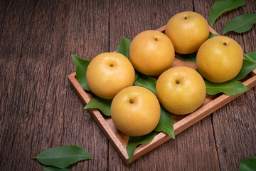 Snow pear or Shingo pear on a wooden background, Korean pear fruits delicious and sweet on wooden background.