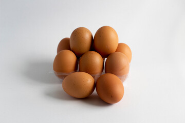 Some eggs and egg holder on white background