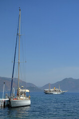 Yachts in bay of Marmaris on background of mountain islands in mist. Summer seascape in Aegean sea