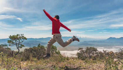 man jumping over rocks in mountain