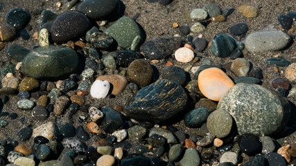 rocks and pebbles on a sandy ocean shore