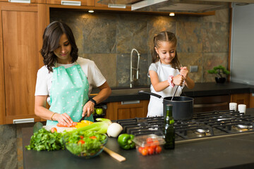 Beautiful woman and kid cooking lunch