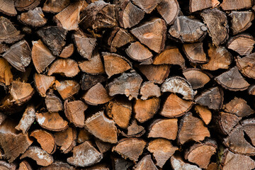 Fototapeta premium Firewood stacked in a continuous pile.