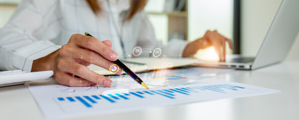 Close up of Business woman accountant or financial expert coins double exposure analyze business report graph finance chart corporate finance economy banking business stock market research concept.

