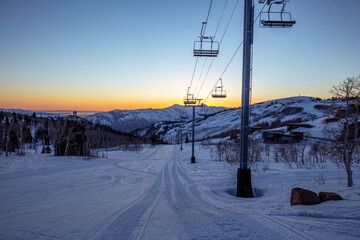 Fototapeta na wymiar Ski lifts at sunset