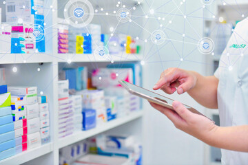 Pharmacist holding computer tablet Using for filling prescription in pharmacy drugstore. Online medical concept