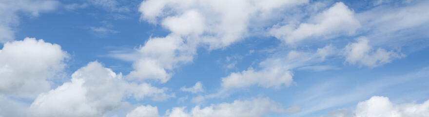 Blue sky background with white clouds. Panorama