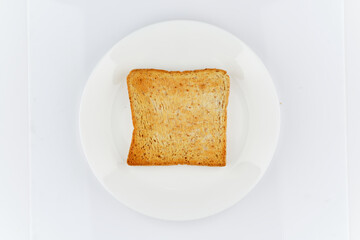 flat lay top view of golden crunchy toasted sliced whole wheat sandwich bread isolated on white dish and white background