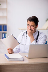 Young male doctor working in the clinic