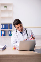 Young male doctor cardiologist working in the clinic