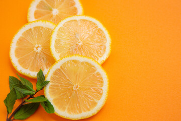 sliced lemons on orange background