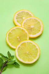 sliced lemons on green background