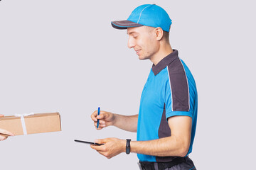Side view photo of a delivery man in postman uniform wearing digital watch on his hand and keeping...