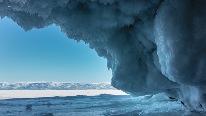 In the cave, rows of fancy blue icicles, similar to lace, hang from the vault of the grotto. The...