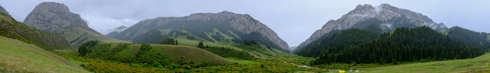 Fototapeta na wymiar Base camp around rocky mountains. Beautiful summer landscape. Komirshi gorge in Kazakhstan.
