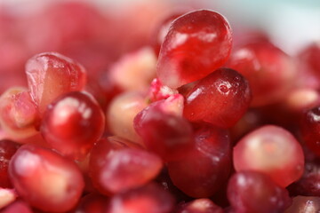  Sweet ripe pomegranate seeds in a porcelain plate