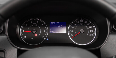 dashboard of the car is illuminated by bright illumination. Speedometer, circle tachometer, oil and...