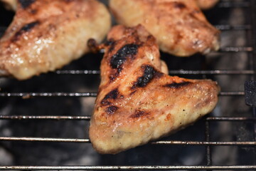 Grilled chicken thigh on the flaming grill