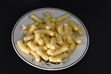 Crunchy, salty corn puffs snacks, also known in Romanian as pufuleti, 