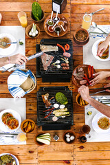group of Friend eating Mexican Tacos and traditional food, snacks and peoples hands over table, top view. Mexican cuisine