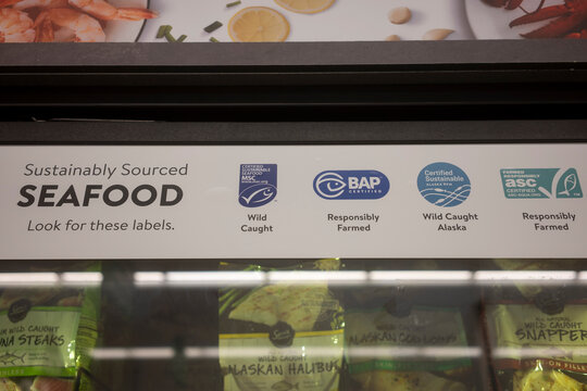West Linn, OR, USA - Sep 7, 2021: Sustainably sourced seafood labels are seen on a merchandiser refrigerator in the Walmart neighborhood market in West Linn, Oregon.