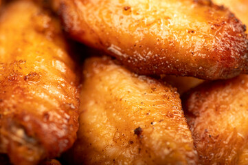 Fried chicken wings on a plate, close-up, selective focus.