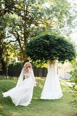 Woman going to her wedding dress that hanging on tree