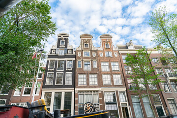 Obraz premium Traditional Dutch architecture with a row of tall thin buildings and three gables rising like towers.