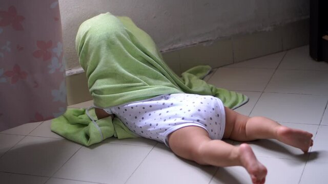 Baby eye is blocked by towel at floor