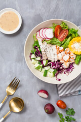 Healthy salad with bio organic vegetables, shrimp and meat with avocado, pepper, radish, tomatoes, lettuce, cabbage, spring colorful salad closeup, clean eating concept. top view