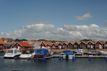 Fototapeta na wymiar Scenic panorama of a waterfront with boats, yachts and houses in Kungshamn (Sotenäs, Västra Götaland, Sweden) on a sunny day in summer