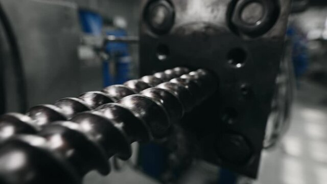 Installation of an automatic line in production. The screws are installed inside. The extruder