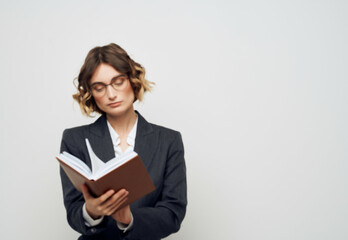 woman with glasses notebook in hand isolated background