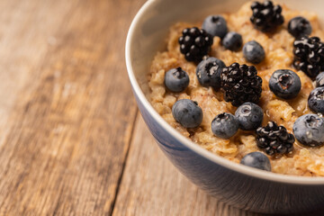 Oatmeal porridge with berries. Selective focus.