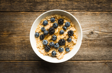 Oatmeal porridge with berries. Selective focus.